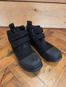 Black rock boots for dry suits with canvas upper and Velcro straps on wooden floor